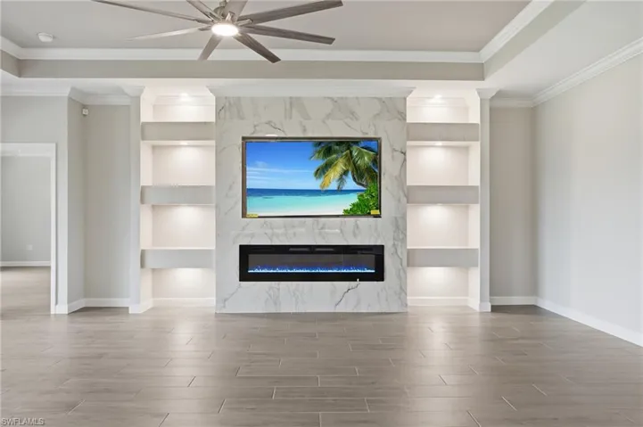Integrated media wall featuring a large screen display and an electric fireplace