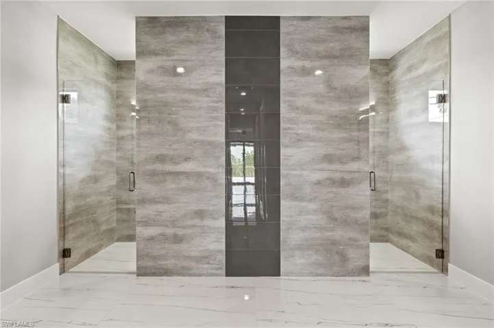 Bathroom featuring walk in shower and tile patterned flooring