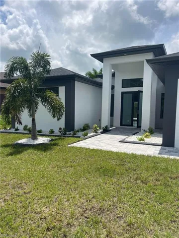 Back of property with a patio area and a yard