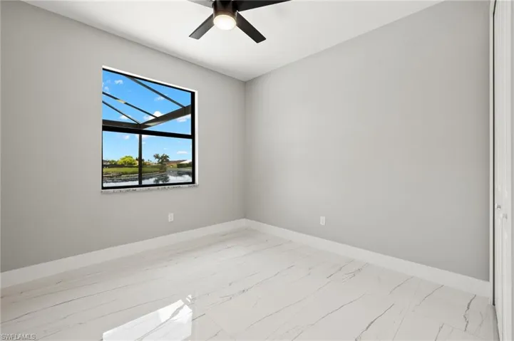 Unfurnished room featuring ceiling fan and tile patterned flooring