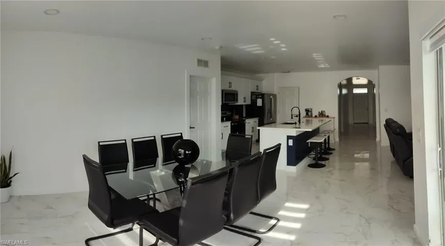Dining room with light marble finish flooring