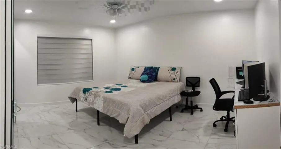 Bedroom with recessed lighting, ceiling fan, and light marble finish flooring