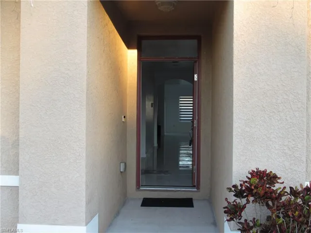 Property entrance featuring stucco siding