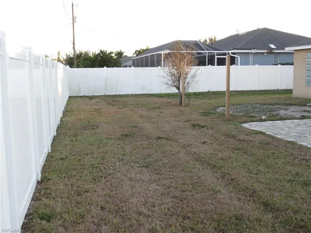 Fenced backyard with a patio