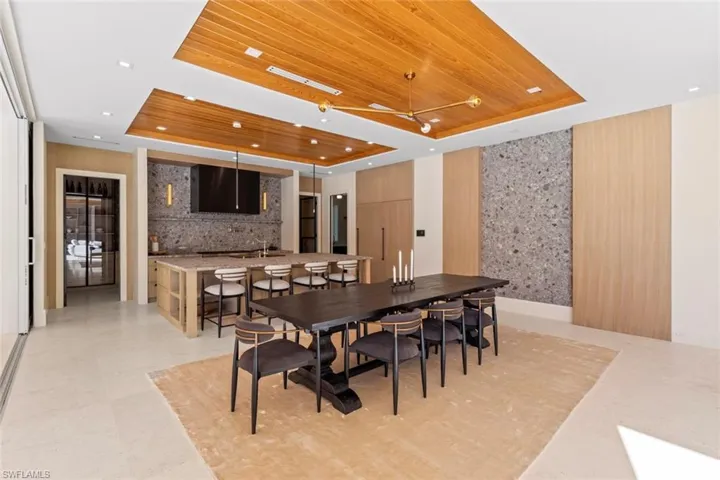 Dining space featuring a tray ceiling and wood ceiling
