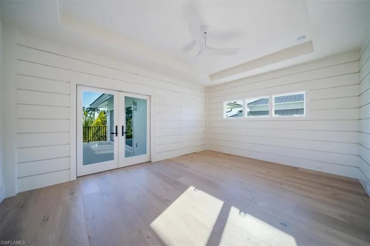 Bedroom #3 with shiplap and balcony access.