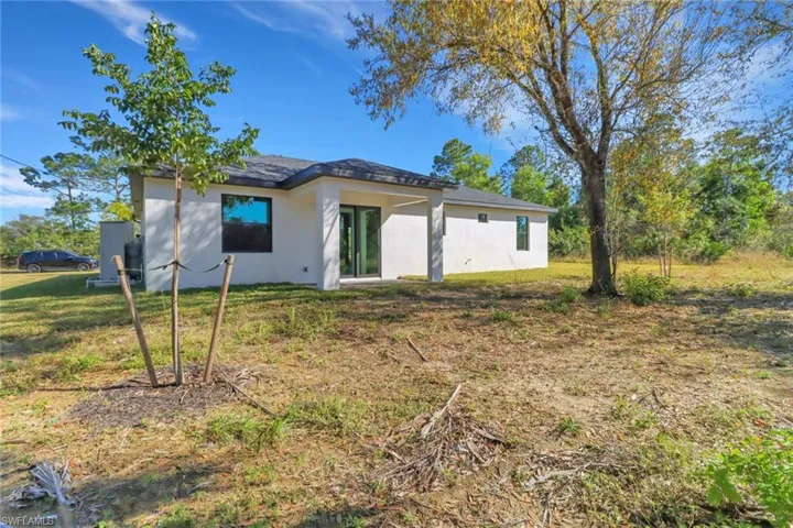 Back of house with a lawn