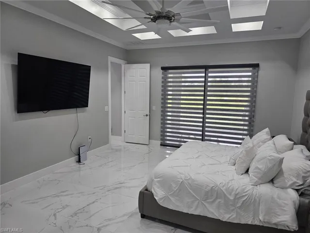 Bedroom featuring ceiling fan and ornamental molding