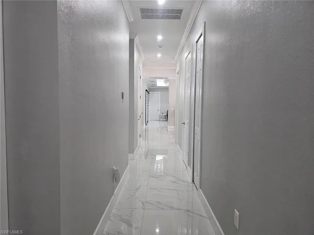 Hall featuring crown molding