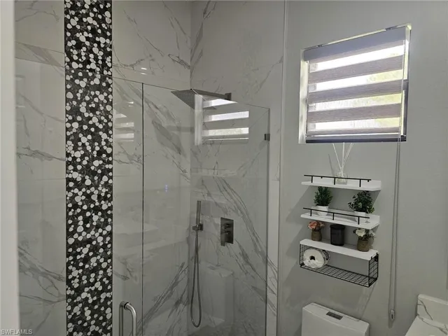 Bathroom featuring toilet and walk in shower