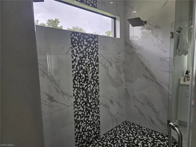 Bathroom with a shower with door