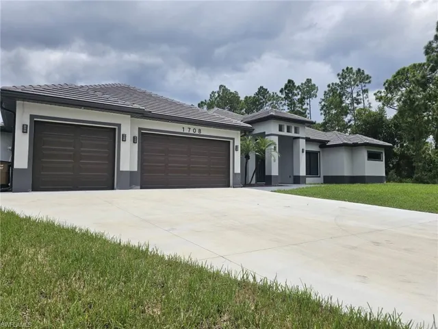 Prairie-style home with a front yard and a garage