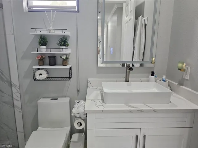 Bathroom featuring toilet and vanity