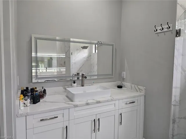 Bathroom with walk in shower and vanity