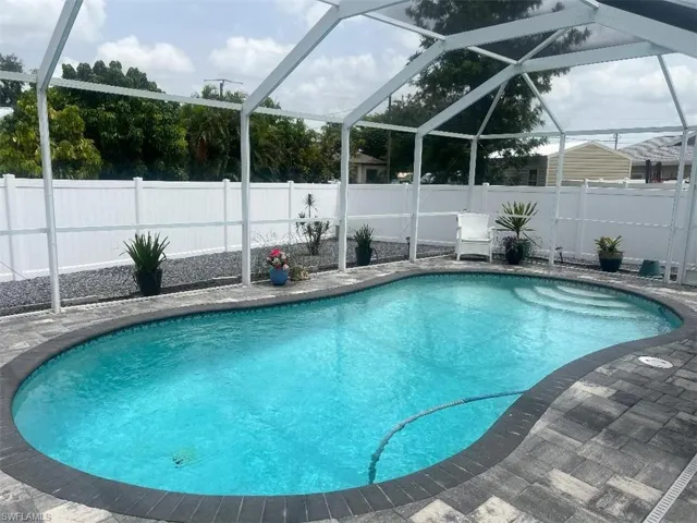 View of pool with a lanai and a patio
