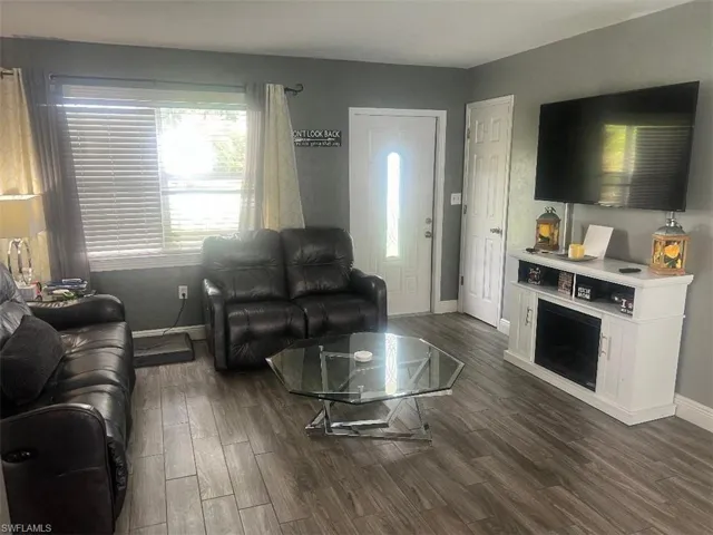 Living room featuring dark hardwood / wood-style flooring