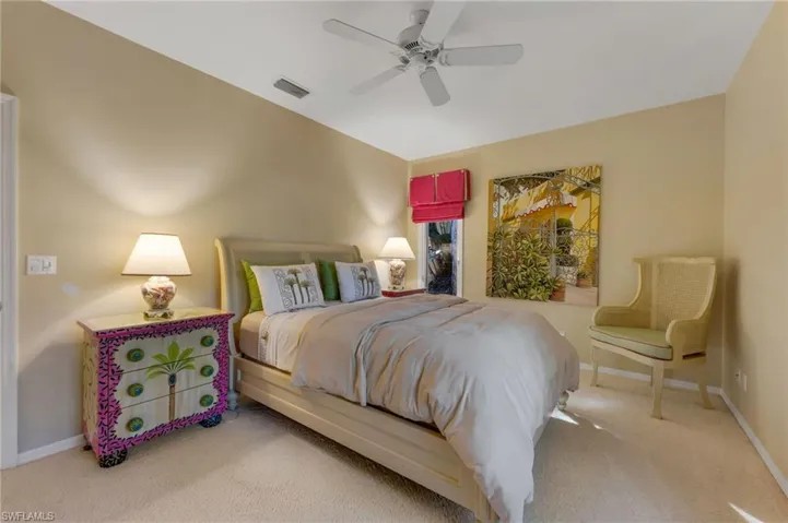 Guest bedroom located at the front of the home with one large window and a smaller off the side.
