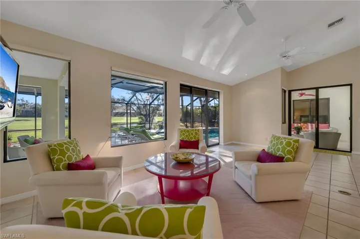 Conversation area overlooking wall of windows/sliders