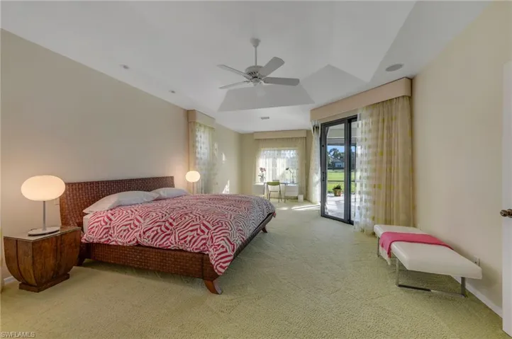 Primary Bedroom is open and has its office with views out to the golf course and lake.  Sliders allow for easy access to outdoor pool/spa area