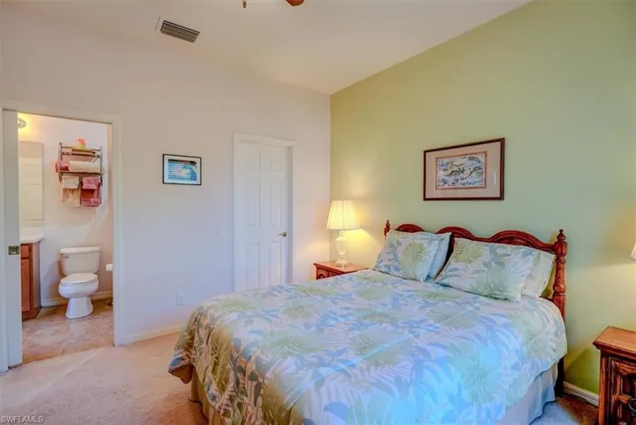 Guest Bedroom with pocket door entrance to guest bathroom