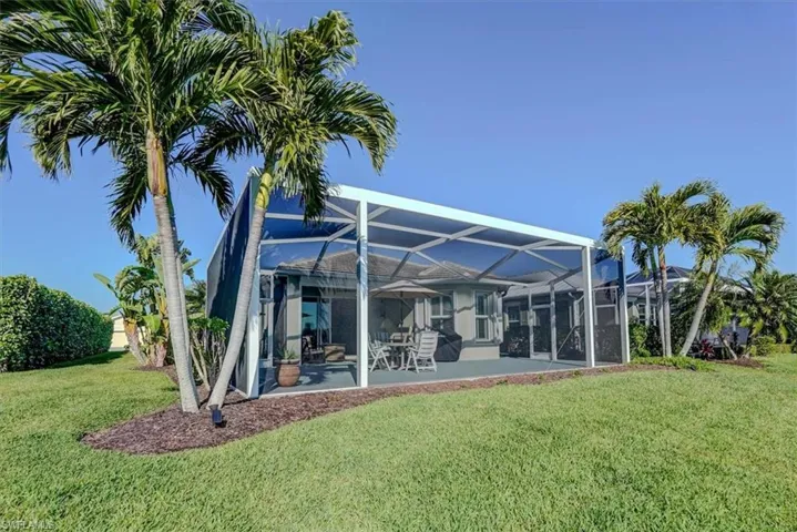 Back of house featuring lanai enclosure