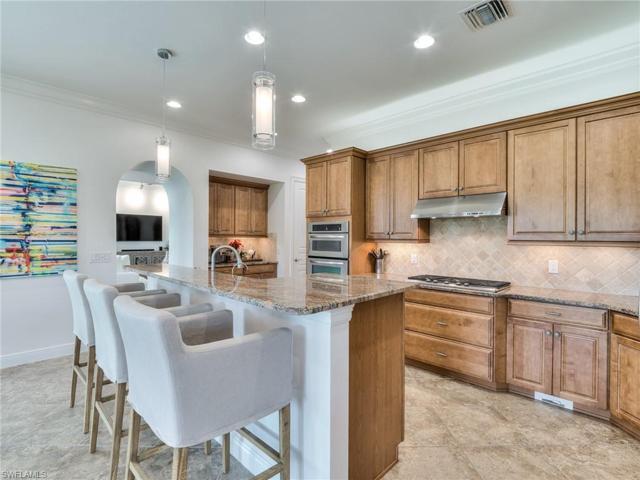 Kitchen with dual pantries, breakfast bar, and five burner natural gas stove-top