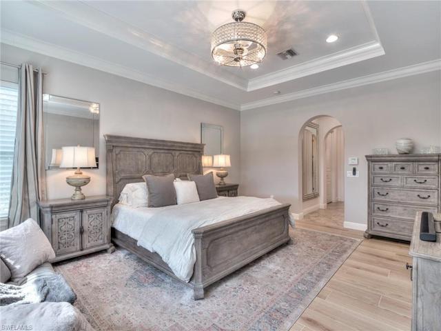 MBR with coffered ceiling, new porcelain wide plank floors 2023, and dual walk-in closets