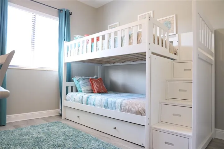 Bedroom with light hardwood / wood-style flooring