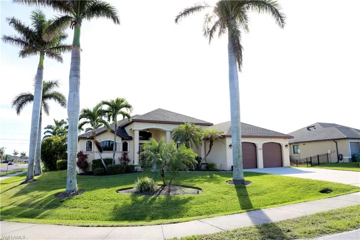 Mediterranean / spanish-style house with a garage and a front yard