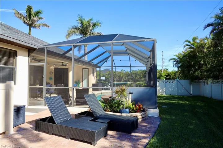 View of patio / terrace featuring a lanai and ceiling fan