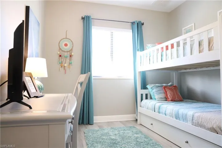 Bedroom with light hardwood / wood-style flooring