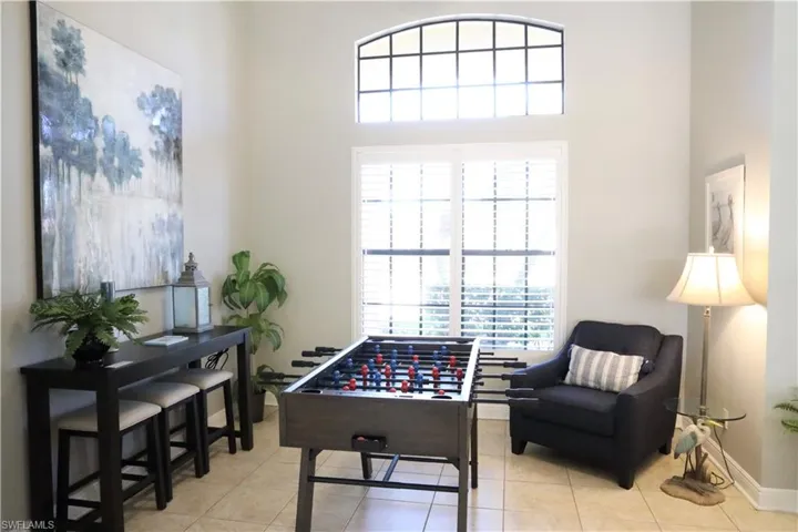 Rec room featuring a wealth of natural light and light tile patterned flooring
