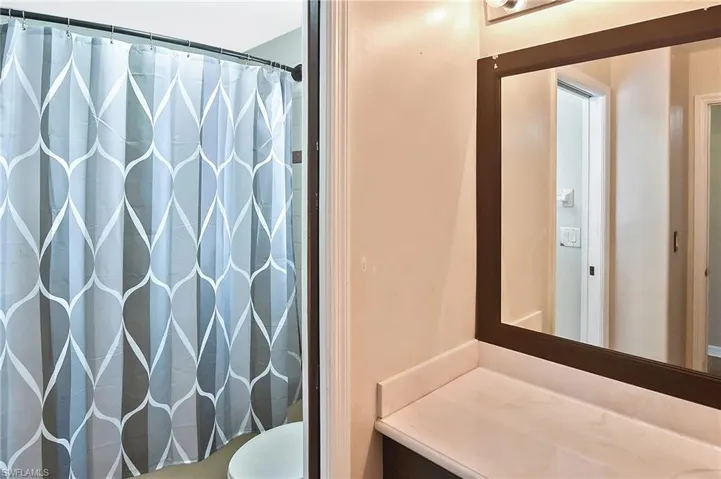 Full bath featuring a shower with shower curtain and vanity