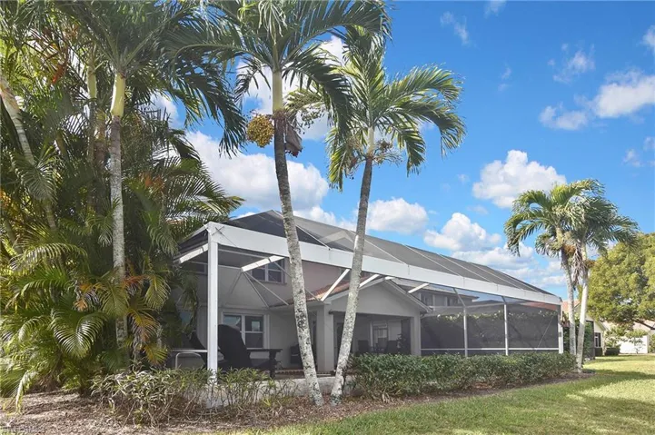 Rear view of property with a sunroom and glass enclosure