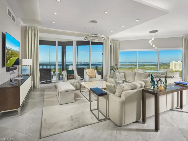Living room featuring a water view and ornamental molding