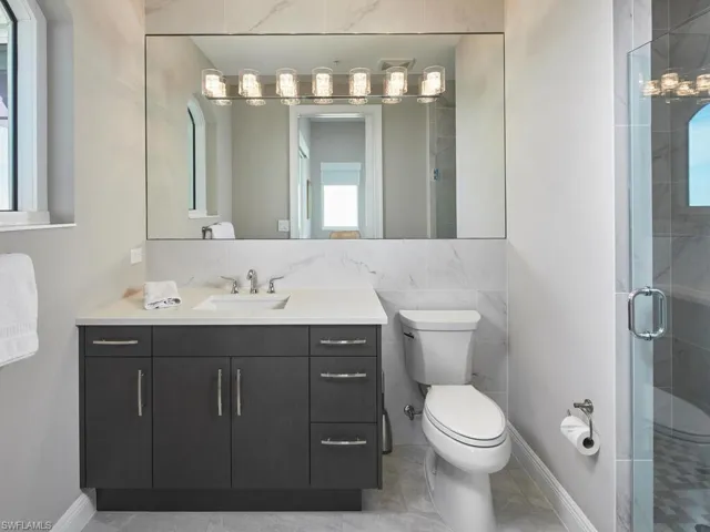Bathroom with vanity, toilet, and walk in shower