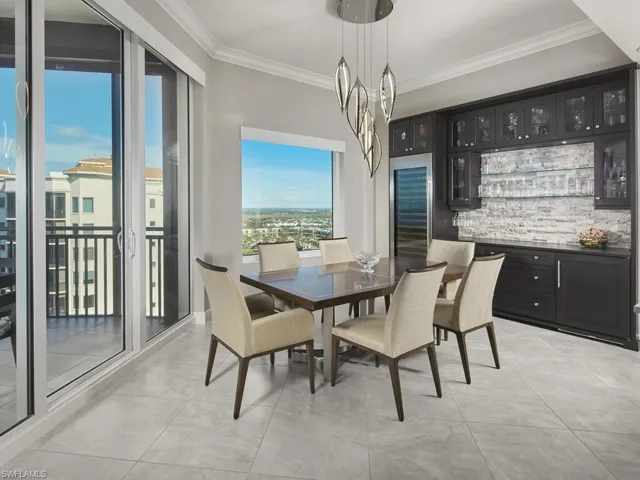 Tiled dining space featuring ornamental molding