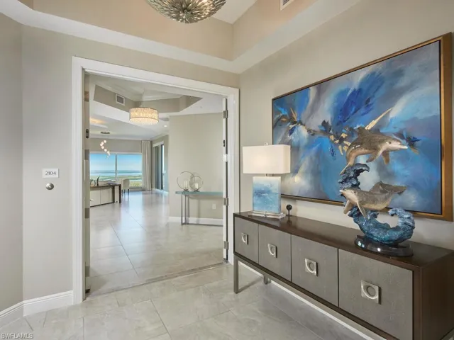 Hall featuring a tray ceiling