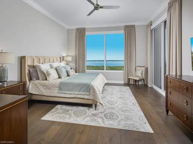 Bedroom with crown molding, dark wood-type flooring, and ceiling fan