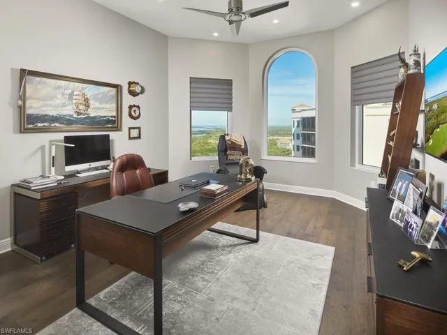 Office space featuring ceiling fan and dark hardwood / wood-style flooring