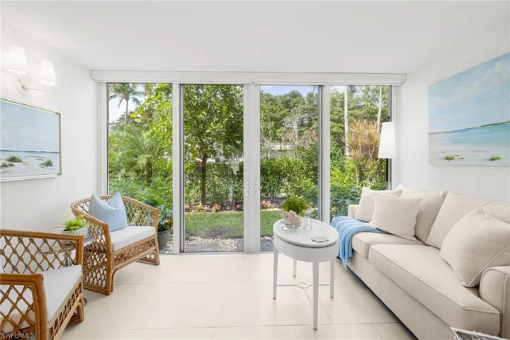 Den, with Glass Impact Sliders, opens to a lovely array of florals and flowering trees