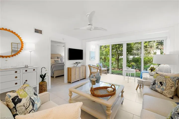 Gorgeous combinations of white linen, organics, original oil paintings, outside garden set the stage for this larger than most FULLY FURNISHED Condo, Walkable to all Naples' has to offer.