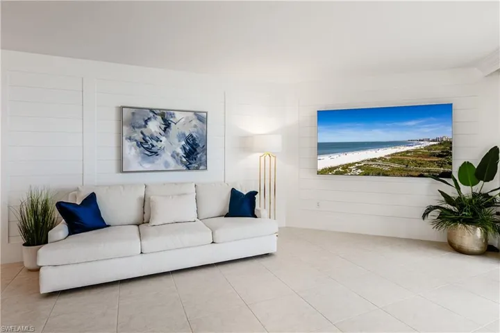 Living room with light tile patterned flooring