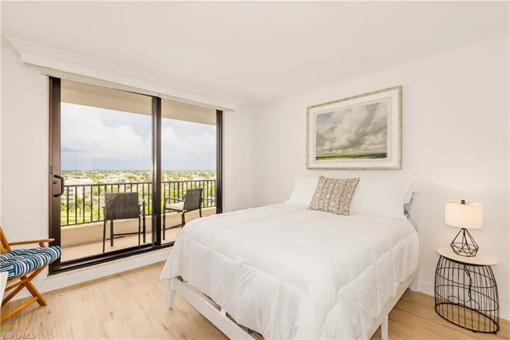 Bedroom featuring wood-type flooring and access to exterior