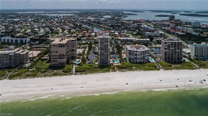 Aerial view featuring a water view and a beach view