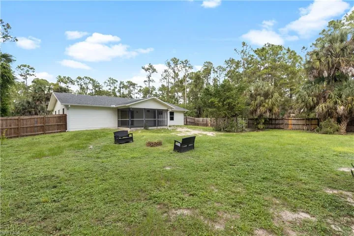 View of yard with a sunroom