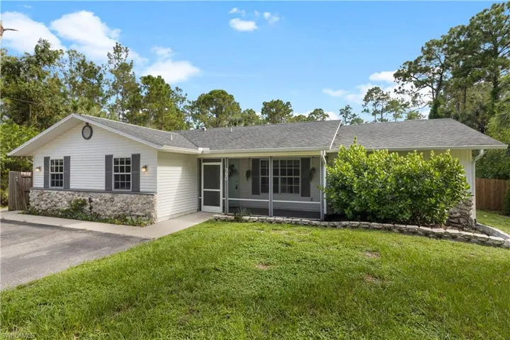 Single story home with a sunroom and a front yard