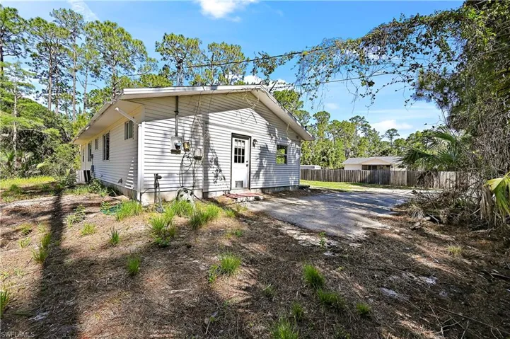 Back of guest house featuring cooling unit and a patio area