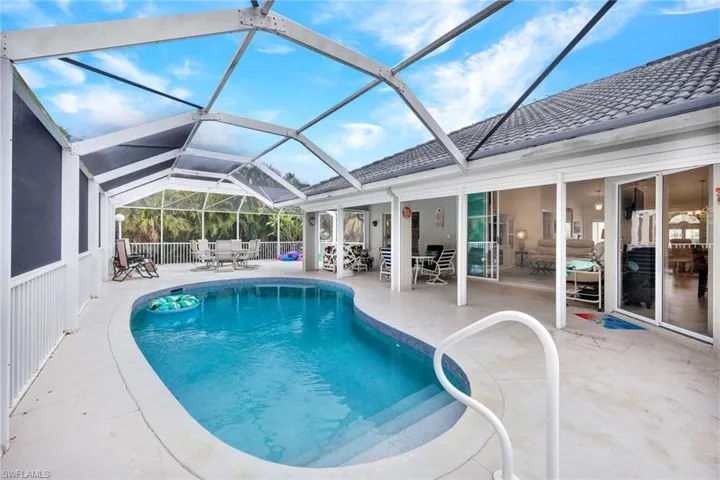 View of swimming pool featuring a lanai and a patio area