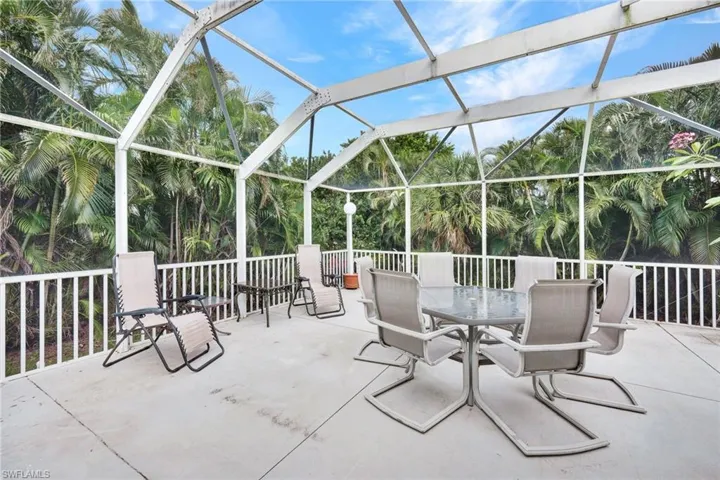 View of patio featuring glass enclosure